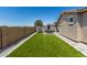 This backyard offers low-maintenance landscaping with artificial turf and a cozy patio area at 17171 W Tonto St, Goodyear, AZ 85338