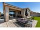 Inviting backyard featuring a paved patio with stylish furniture and lush artificial turf at 17171 W Tonto St, Goodyear, AZ 85338