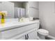Bright bathroom featuring a white vanity, sink, and toilet at 17171 W Tonto St, Goodyear, AZ 85338