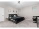 Neutral bedroom featuring a gray upholstered bed and carpeted floor at 17171 W Tonto St, Goodyear, AZ 85338