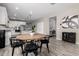 Open dining area shows table adjacent to a modern kitchen with white cabinets and stainless steel appliances at 17171 W Tonto St, Goodyear, AZ 85338