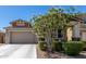 Charming single-Gathering home boasts desert landscaping, a two-car garage, and a covered porch with stone accents at 17171 W Tonto St, Goodyear, AZ 85338