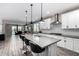 Open concept kitchen with island, seating, and stainless steel appliances at 17171 W Tonto St, Goodyear, AZ 85338