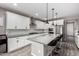 Modern kitchen with white cabinets, stainless steel appliances, a stylish island, and pendant lighting fixtures at 17171 W Tonto St, Goodyear, AZ 85338
