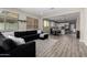Open-concept living area features wood-look floors, plentiful natural light, and seamless flow to the modern kitchen at 17171 W Tonto St, Goodyear, AZ 85338
