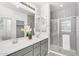 Bathroom showcases a double sink vanity, a large mirror, and a glass enclosed shower at 1727 E Chelsea Ln, Gilbert, AZ 85295