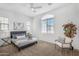 Spacious bedroom featuring a large window, neutral decor, and a cozy sitting area at 1727 E Chelsea Ln, Gilbert, AZ 85295