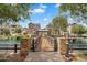View of a wood bridge leading to a gazebo surrounded by apartments and a pond at 1727 E Chelsea Ln, Gilbert, AZ 85295