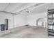 Spacious garage with concrete flooring and white walls, and storage racks at 1727 E Chelsea Ln, Gilbert, AZ 85295