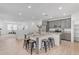 Open kitchen boasts granite countertops, stainless steel appliances, and an island with seating, perfect for entertaining at 1727 E Chelsea Ln, Gilbert, AZ 85295
