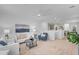 Open-concept living space with neutral carpet, stylish furniture, and seamless access to the kitchen and dining area at 1727 E Chelsea Ln, Gilbert, AZ 85295