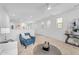 Spacious living room featuring neutral carpet, open layout, and a calming blue accent chair at 1727 E Chelsea Ln, Gilbert, AZ 85295
