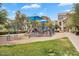 Well-maintained playground area with slides, climbing structures, and blue sun shades for ' enjoyment at 1727 E Chelsea Ln, Gilbert, AZ 85295