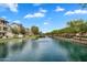 Scenic water view featuring lush landscaping, beautiful architecture, and a tranquil fountain at 1727 E Chelsea Ln, Gilbert, AZ 85295