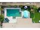 Aerial view of a backyard with a pool, outdoor seating, putting green, and lush landscaping at 1831 E Cornell Dr, Tempe, AZ 85283