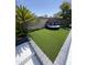 Cozy backyard with artificial turf, a comfortable outdoor sofa, and privacy wall at 1831 E Cornell Dr, Tempe, AZ 85283