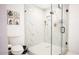 Elegant bathroom showcasing a frameless glass shower, white marble walls, and sleek fixtures at 1831 E Cornell Dr, Tempe, AZ 85283
