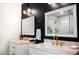 Modern bathroom featuring dual vanities with white marble countertops, gold fixtures, and a glass-enclosed shower at 1831 E Cornell Dr, Tempe, AZ 85283