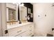 Modern bathroom with double sinks, gold fixtures, and a stylish vanity with marble countertop at 1831 E Cornell Dr, Tempe, AZ 85283