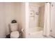 Clean bathroom featuring white fixtures, a toilet, and a bathtub-shower combination with marble tile at 1831 E Cornell Dr, Tempe, AZ 85283