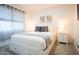 Bright bedroom featuring a white bed frame with storage drawers, neutral decor, and ample natural light at 1831 E Cornell Dr, Tempe, AZ 85283