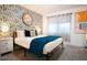 Trendy bedroom with patterned accent wall, black metal bed frame, and contemporary artwork at 1831 E Cornell Dr, Tempe, AZ 85283