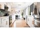 Bright kitchen with white cabinetry and stainless steel appliances, offering a sleek and functional cooking space at 1831 E Cornell Dr, Tempe, AZ 85283