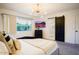 Relaxing bedroom featuring a large window, modern lighting, and a stylish en-suite bathroom with a barn door at 1831 E Cornell Dr, Tempe, AZ 85283