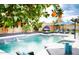 Backyard pool area with lush citrus trees, a lounge bed, and comfortable seating for outdoor relaxation at 1831 E Cornell Dr, Tempe, AZ 85283