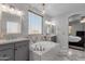 Serene bathroom with a large soaking tub, dual vanities, and a glimpse into the primary bedroom at 18501 E Pine Valley Dr, Queen Creek, AZ 85142
