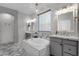 Bright bathroom with patterned tile surrounding the soaking tub, dual vanities, and ample natural light at 18501 E Pine Valley Dr, Queen Creek, AZ 85142