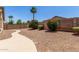 Spacious backyard with gravel, brick wall, and desert landscaping at 2191 W Goldmine Mountain Dr, Queen Creek, AZ 85144