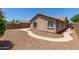 Back of house with gravel, walkway, and block wall at 2191 W Goldmine Mountain Dr, Queen Creek, AZ 85144