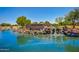 Stunning community entrance featuring a rock waterfall and pond at 2191 W Goldmine Mountain Dr, Queen Creek, AZ 85144