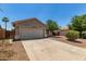 Single level home with desert landscaping, two car garage and a concrete driveway at 2191 W Goldmine Mountain Dr, Queen Creek, AZ 85144