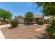 Single-story home showcasing desert landscaping, a concrete driveway and a two car garage at 2191 W Goldmine Mountain Dr, Queen Creek, AZ 85144
