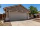 Attached two car garage featuring desert landscaping and durable concrete driveway at 2191 W Goldmine Mountain Dr, Queen Creek, AZ 85144