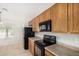 Kitchen with light tile flooring and black appliances at 2191 W Goldmine Mountain Dr, Queen Creek, AZ 85144