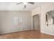 Neutral living room with laminate floors, archway and a large window at 2191 W Goldmine Mountain Dr, Queen Creek, AZ 85144