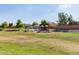 Community playground featuring slides and play structures surrounded by open green space at 2191 W Goldmine Mountain Dr, Queen Creek, AZ 85144