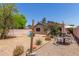 Landscaped backyard featuring gravel, seating, table, shade umbrella, and mature trees at 22056 N 32Nd Ave, Phoenix, AZ 85027