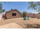 Gravel backyard featuring a home's rear, outdoor seating, landscaping, and fence at 22056 N 32Nd Ave, Phoenix, AZ 85027