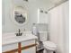 Clean bathroom with a single sink vanity, white toilet, and shower with a curtain at 22056 N 32Nd Ave, Phoenix, AZ 85027