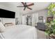 Comfortable bedroom with a ceiling fan, dark dresser, a mounted TV, and a walk-in closet at 22056 N 32Nd Ave, Phoenix, AZ 85027