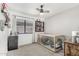 Bright bedroom with ceiling fan, carpeted floor, and a large window with backyard view at 22056 N 32Nd Ave, Phoenix, AZ 85027
