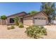 Single-level house featuring desert landscaping, neutral tones, and a two-car garage at 22056 N 32Nd Ave, Phoenix, AZ 85027