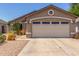 Single-story home featuring a two-car garage and low-maintenance desert landscaping at 22056 N 32Nd Ave, Phoenix, AZ 85027