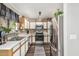 Galley kitchen featuring stainless steel appliances, a neutral color scheme, and ample counter space at 22056 N 32Nd Ave, Phoenix, AZ 85027
