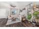 Bright living area with a ceiling fan, L-shaped sofa, and dark wood floors at 22056 N 32Nd Ave, Phoenix, AZ 85027