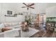 Living area featuring a light-colored sofa, ceiling fan, and stylish decor at 22056 N 32Nd Ave, Phoenix, AZ 85027